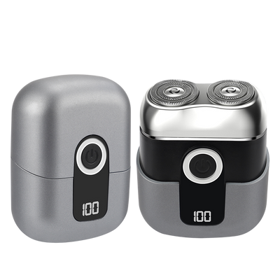 Silver and black electric shaver on a white background