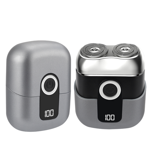 Silver and black electric shaver on a white background